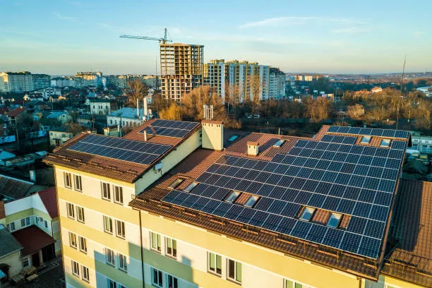 Bloque de pisos con instalación solar en la azotea ilustrando las ventajas de la energía solar en zonas muy pobladas
